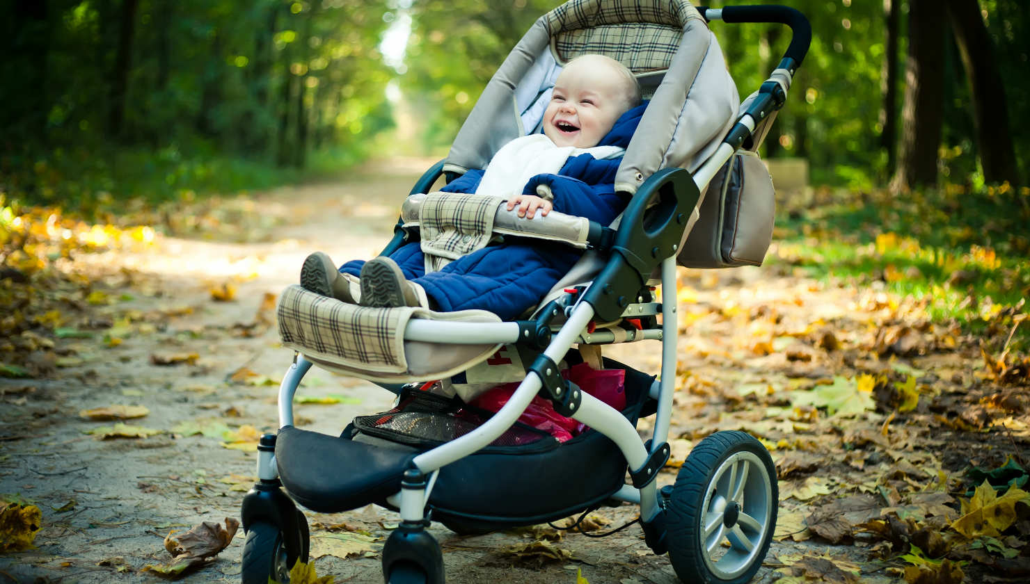 happy baby in baby stroller