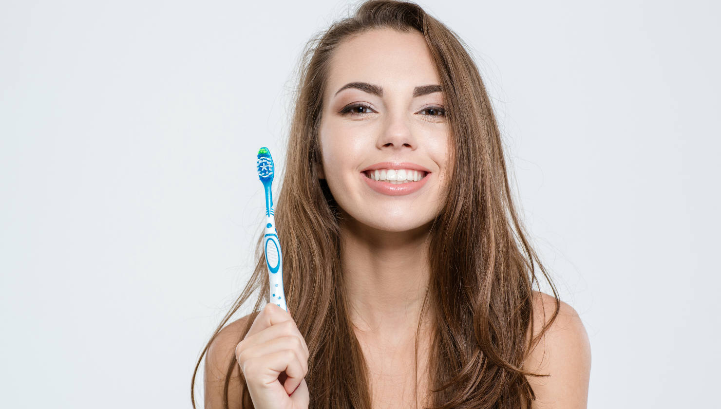 woman holding toothbrush