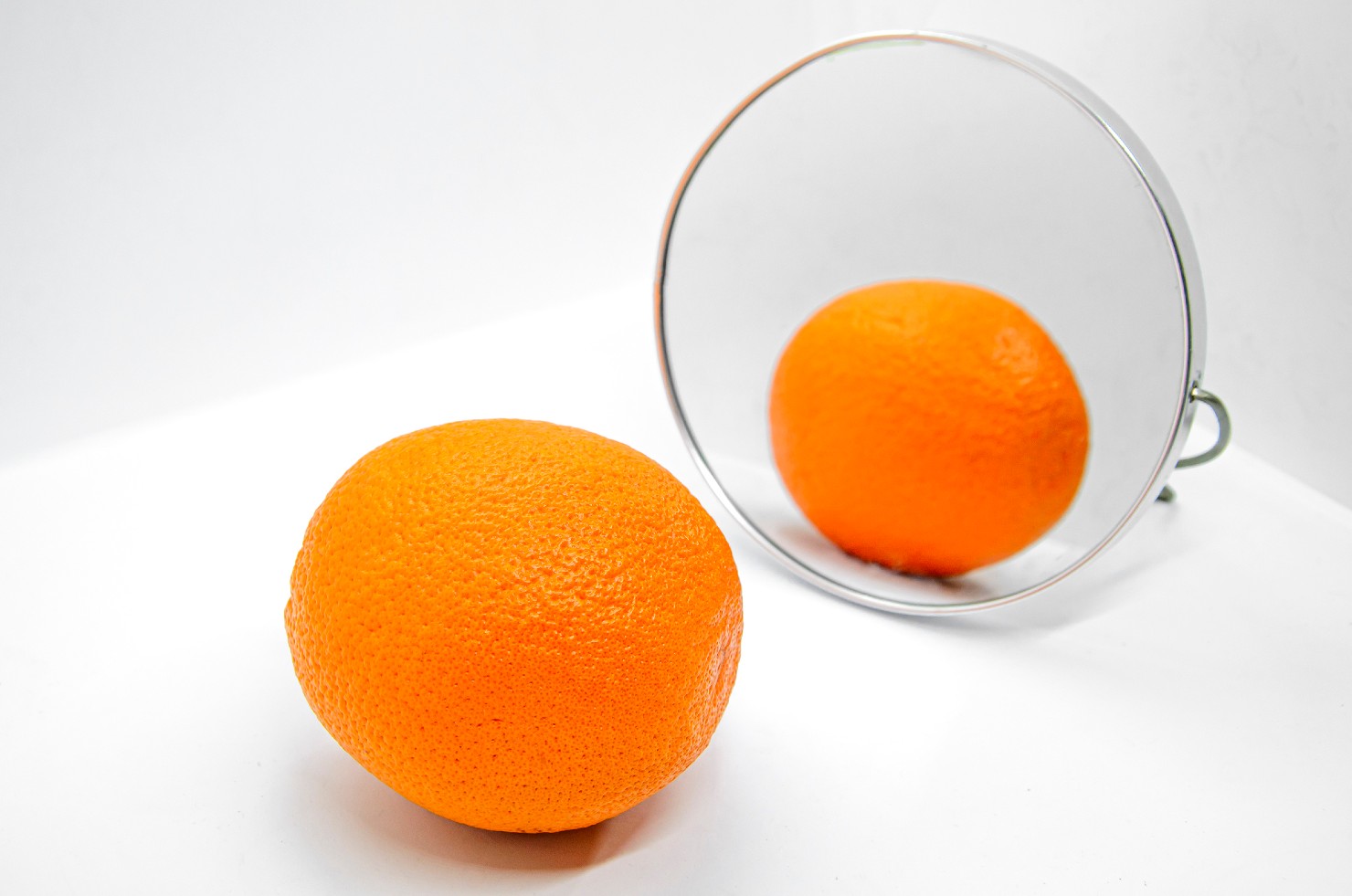orange in front of mirror